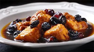 photo of a dish full of sweet and sour carp chunks in a brown sugar sauce