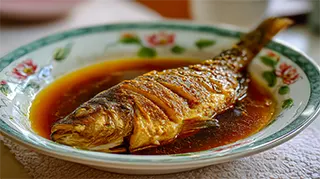 photo of steamed carp in egg custard with a soy sesame sauce
