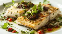 photo of baked sea bass with black olive sauce
