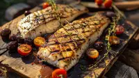 photo of grilled sea bass fillets with olives, tomatoes and garlic