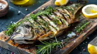 photo of a grilled sea bass slashed and stuffed with herbs