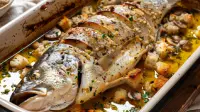 photo of a whole stuffed sea bass with mushrooms, croutons and garlic